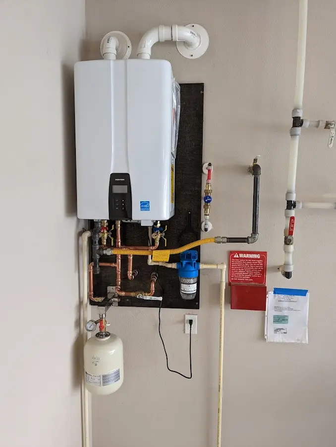 Professional plumber installing copper piping in a Weston home